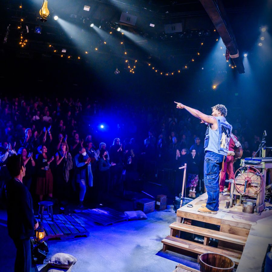 Energetic audience members in the theatre on opening night of Mexodus.